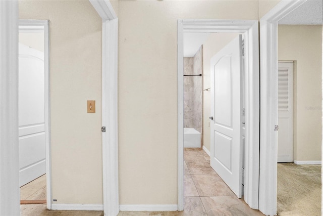 hallway featuring baseboards