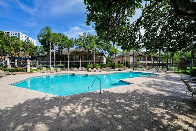 pool featuring fence and a patio