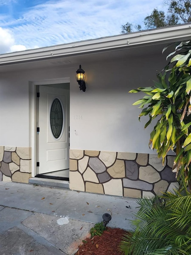 entrance to property featuring stone siding