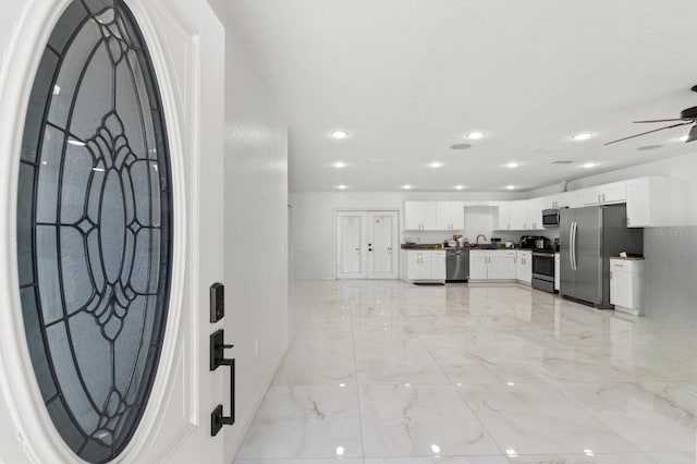 foyer entrance with recessed lighting, marble finish floor, baseboards, and a ceiling fan