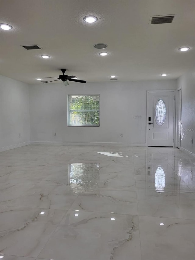 empty room with recessed lighting, visible vents, and marble finish floor