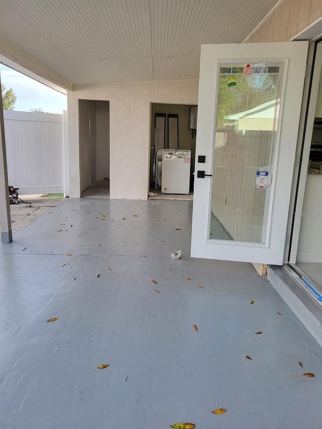 view of patio featuring washer / clothes dryer and fence