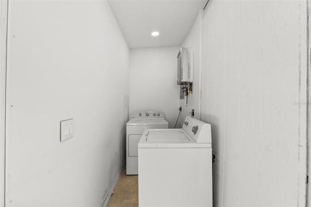 clothes washing area featuring laundry area and washer and clothes dryer