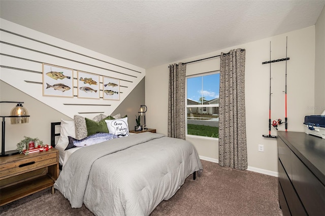 bedroom featuring dark carpet, a textured ceiling, and baseboards