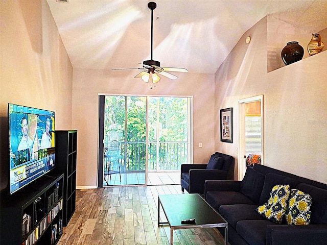 living room featuring ceiling fan, high vaulted ceiling, and wood finished floors