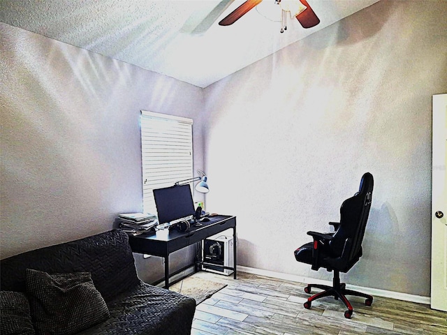 home office featuring ceiling fan, baseboards, and wood finished floors