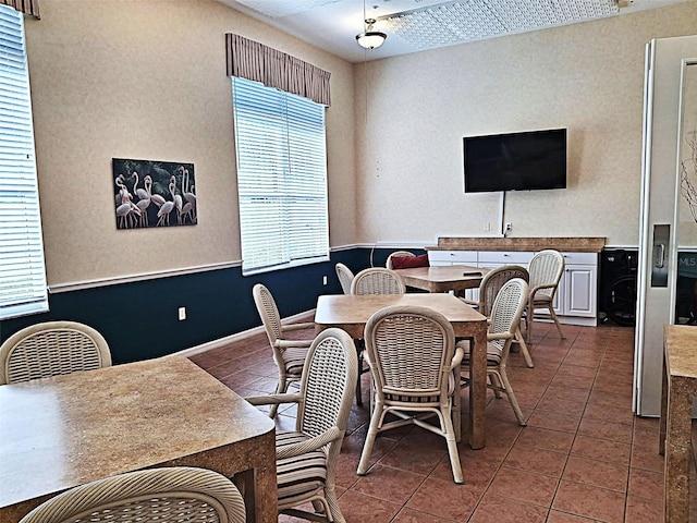 dining area with a wealth of natural light and tile patterned floors