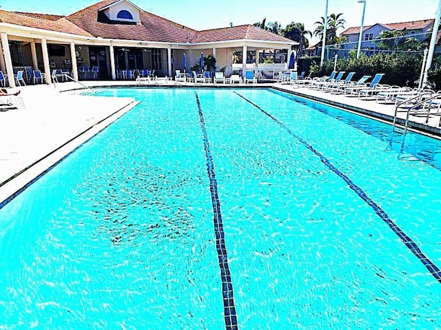 community pool featuring a patio and fence