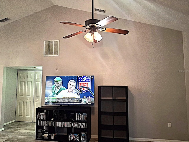 interior space featuring a ceiling fan, visible vents, and wood finished floors
