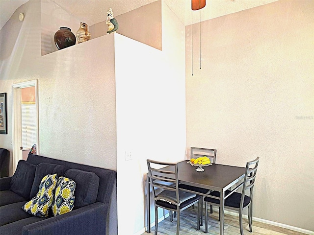 dining room with baseboards, a ceiling fan, and wood finished floors