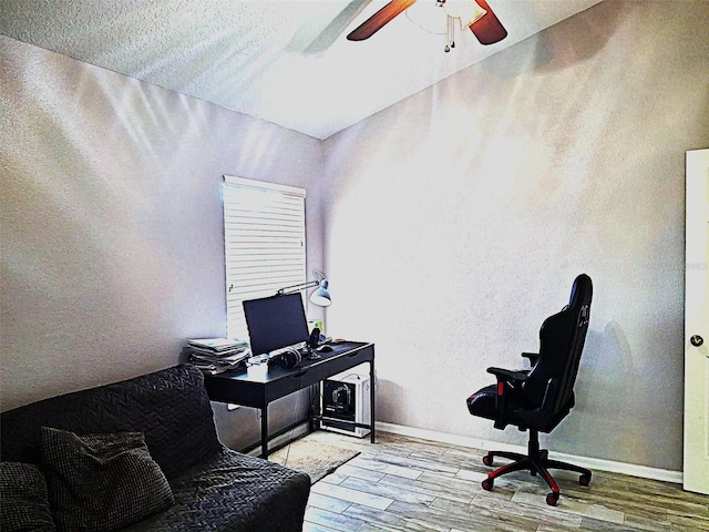 office featuring baseboards, a ceiling fan, and wood finished floors