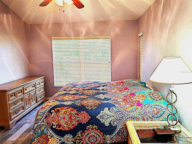 bedroom featuring a ceiling fan and dark wood-style flooring
