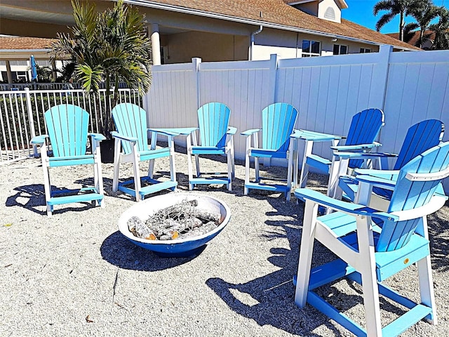 view of patio / terrace featuring an outdoor fire pit and fence