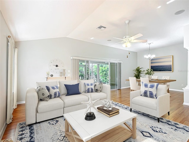 living area with a ceiling fan, baseboards, visible vents, lofted ceiling, and light wood-type flooring