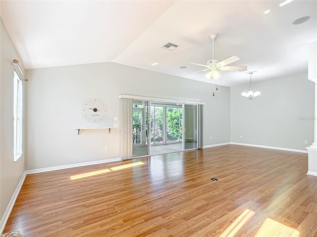 unfurnished living room with light wood finished floors, visible vents, baseboards, and lofted ceiling