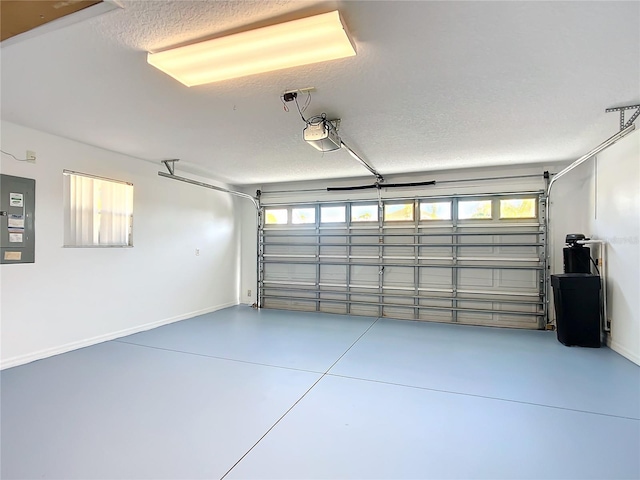 garage featuring electric panel, a garage door opener, and baseboards