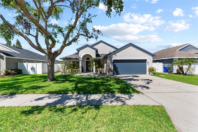 ranch-style home with a front lawn, fence, stucco siding, driveway, and an attached garage