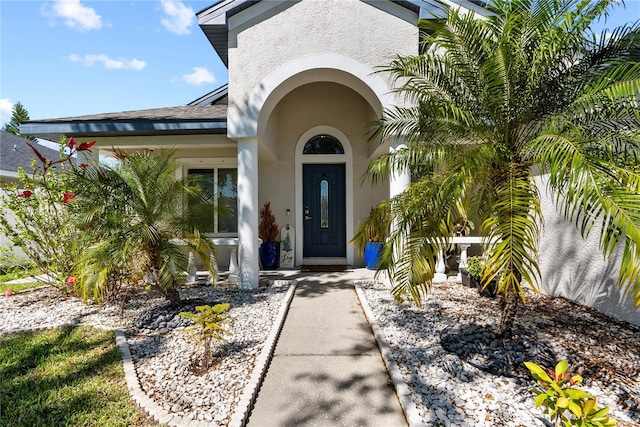 property entrance featuring stucco siding