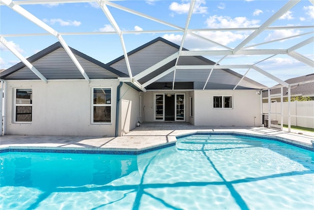 view of swimming pool featuring a fenced in pool, a patio, and glass enclosure