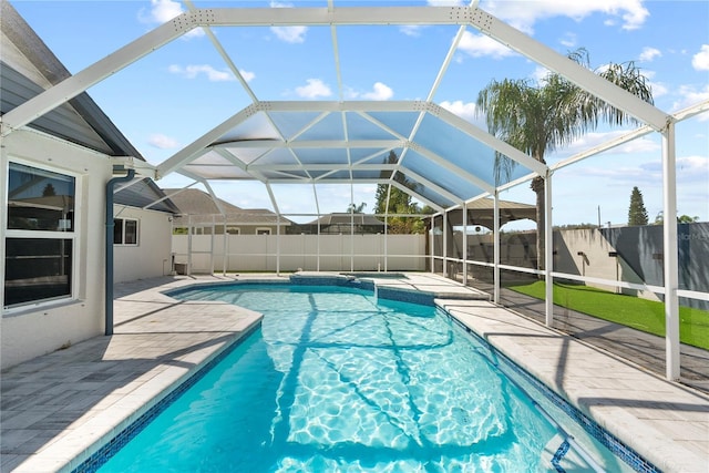 view of swimming pool with a lanai, a patio, and a fenced backyard