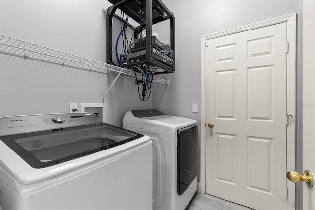 laundry room featuring washing machine and dryer and laundry area