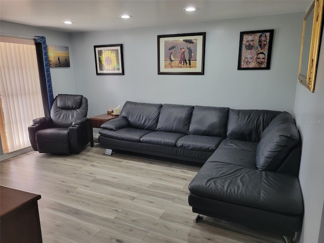 living area with recessed lighting and light wood finished floors