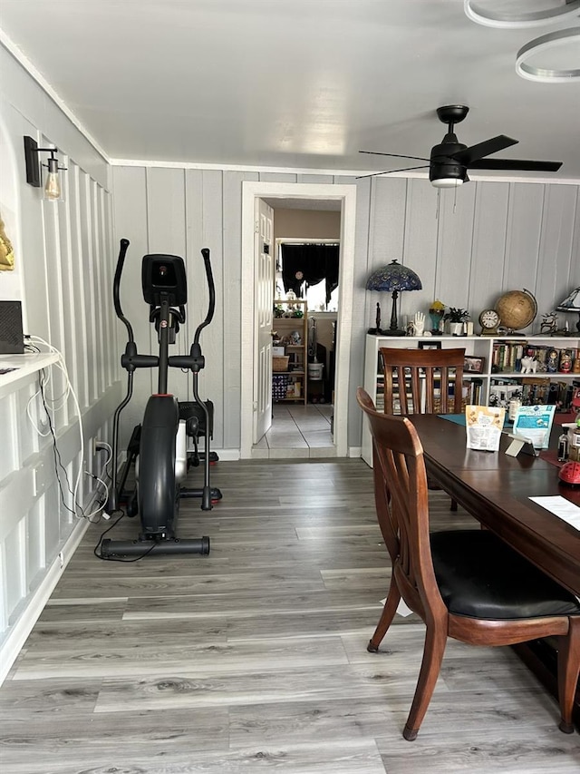 workout room with ceiling fan and wood finished floors