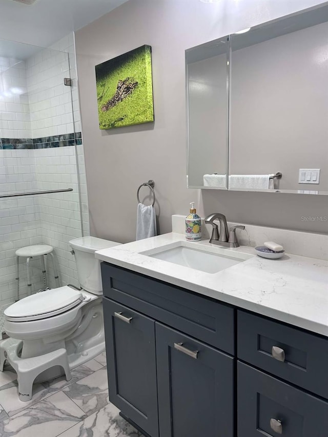 bathroom with toilet, marble finish floor, vanity, and a stall shower