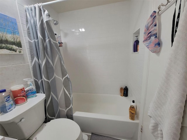 bathroom with shower / bath combo, toilet, and tile walls