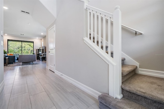 stairway featuring recessed lighting, visible vents, and baseboards