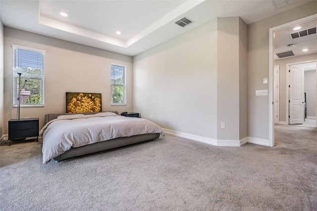 carpeted bedroom with recessed lighting, a raised ceiling, visible vents, and baseboards