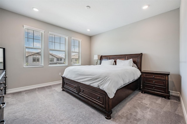 bedroom featuring baseboards, recessed lighting, and light colored carpet