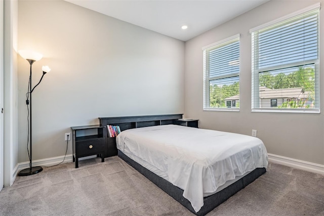 bedroom with recessed lighting, baseboards, and light colored carpet