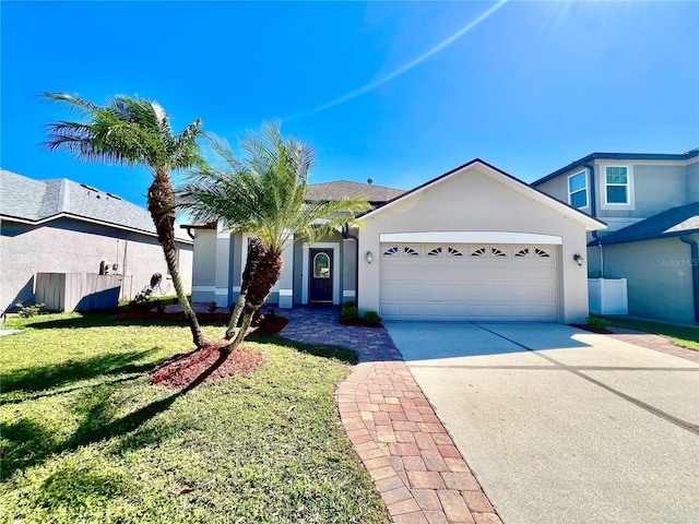 view of front of house with an attached garage, driveway, a front yard, and stucco siding