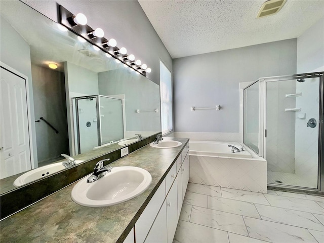 bathroom featuring marble finish floor, visible vents, and a sink