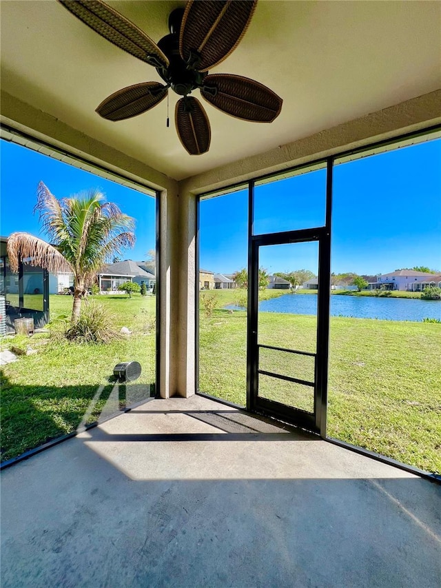 unfurnished sunroom featuring a water view