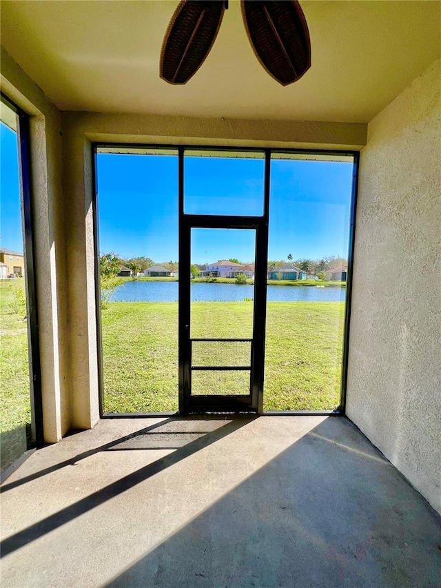 unfurnished sunroom with a water view and plenty of natural light