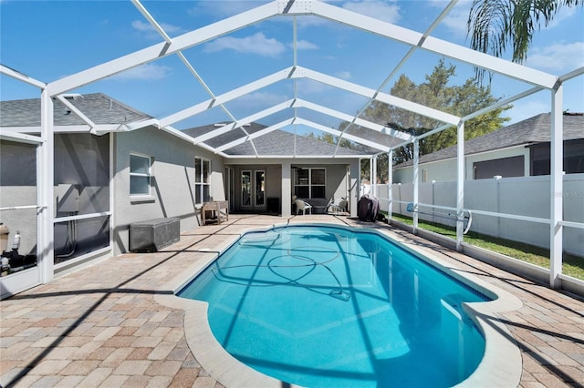 view of pool with a fenced in pool, fence private yard, glass enclosure, and a patio