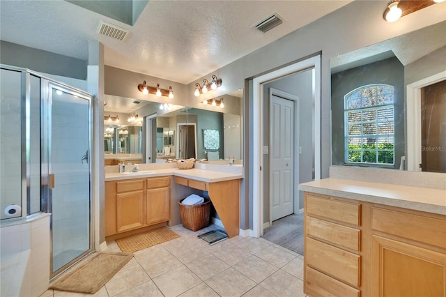 bathroom with tile patterned floors, visible vents, and a shower stall