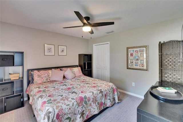 bedroom with a ceiling fan, visible vents, baseboards, a closet, and carpet flooring