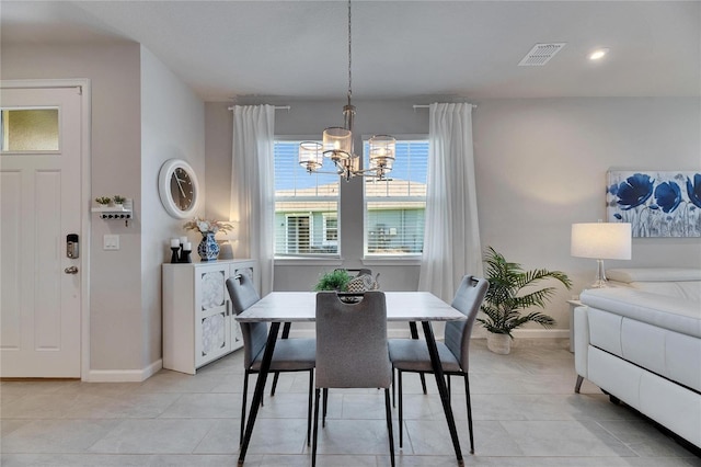 dining room featuring a chandelier, light tile patterned floors, visible vents, and baseboards