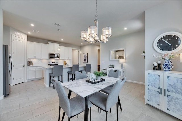 dining space with a chandelier, recessed lighting, visible vents, and baseboards