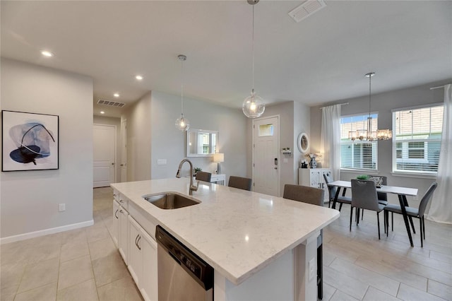 kitchen with a center island with sink, visible vents, dishwasher, light stone countertops, and a sink