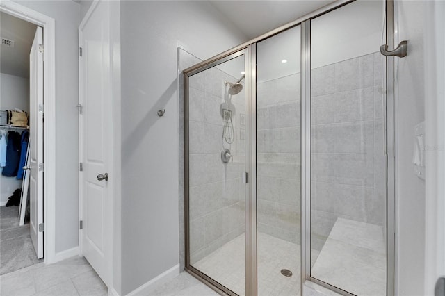 full bath with baseboards, a shower stall, visible vents, and tile patterned floors