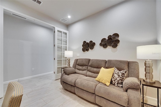 living room with recessed lighting, visible vents, and baseboards