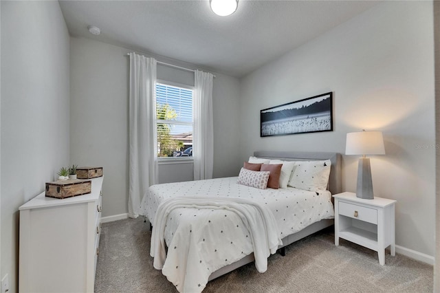 bedroom featuring carpet floors and baseboards