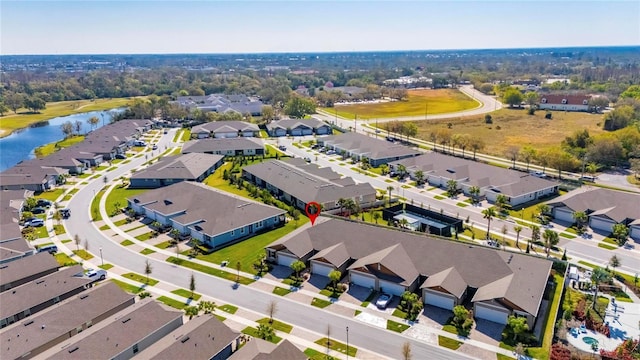 bird's eye view with a water view and a residential view