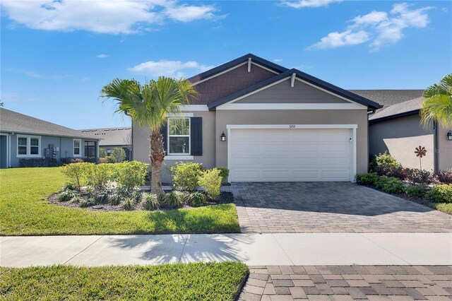 3753 Maxwell Park Dr, Sun City Center, FL 33573 - view of front of property featuring driveway, a garage, stucco siding, and a front yard