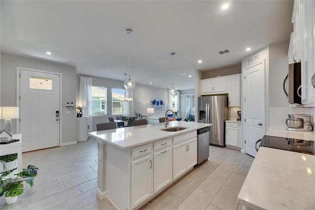 3753 Maxwell Park Dr, Sun City Center, FL 33573 - kitchen with appliances with stainless steel finishes, a sink, light tile patterned floors, white cabinets, and recessed lighting