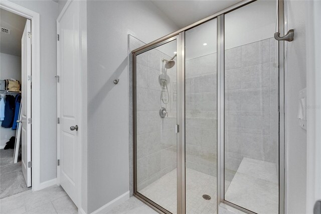 3753 Maxwell Park Dr, Sun City Center, FL 33573 - bathroom with a shower stall, tile patterned floors, and baseboards